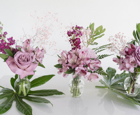small purple arrangements in mini vases