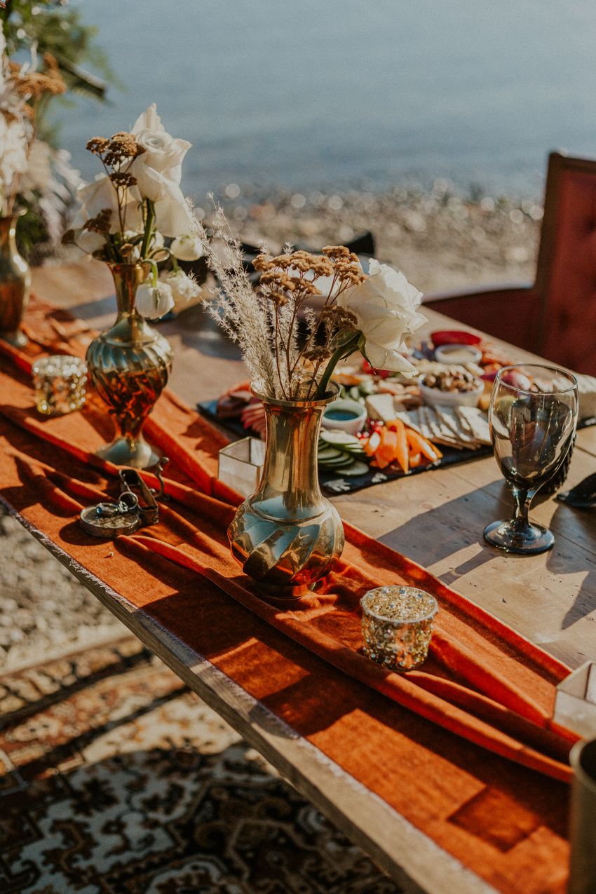 A bohemian DIY wedding centerpiece with dried flowers and white roses