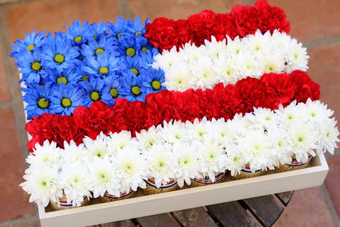 Red white and blue flag made of flowers.
