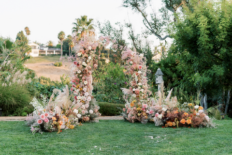 stunning flower arch with pink and coral flowers and dried flowers