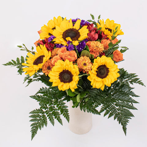 sunflower and aster bouquet in a white vase