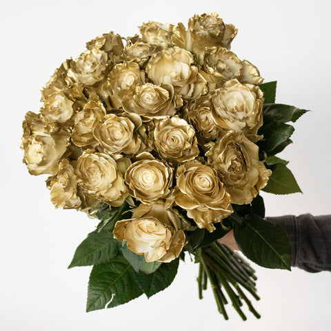 bunches of gold roses being held in hand