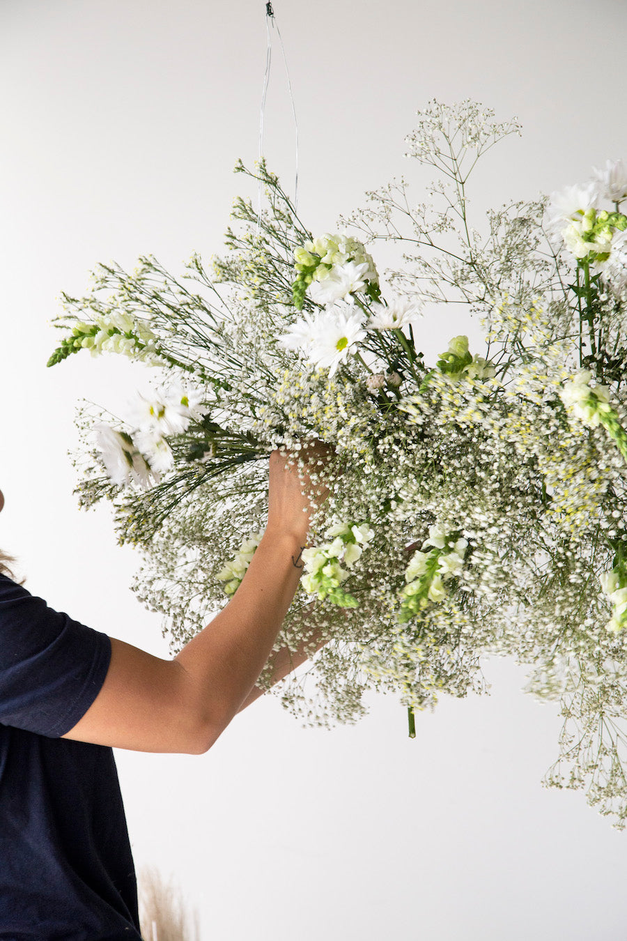 Hanging floral installation with white daisies.