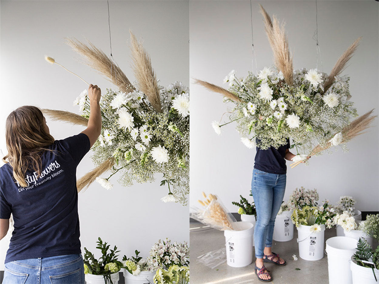 Adding pampas grass to a hanging floral installation.