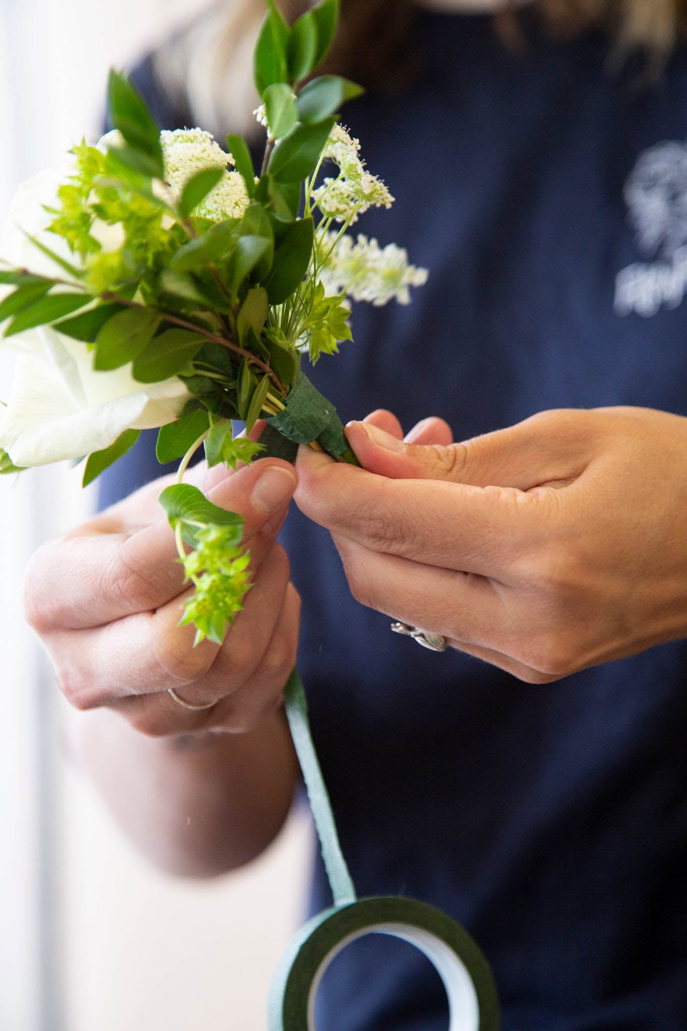 How to make a boutonniere, Step 7: Continue layering focal, filler, and greenery stems