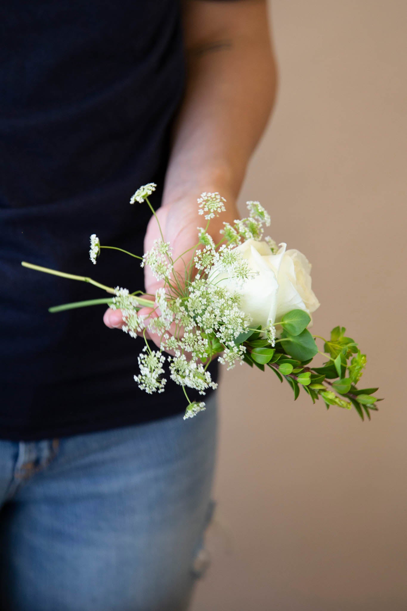 Similarly to designing a boutonniere, add filler flowers to your corsage for dimension