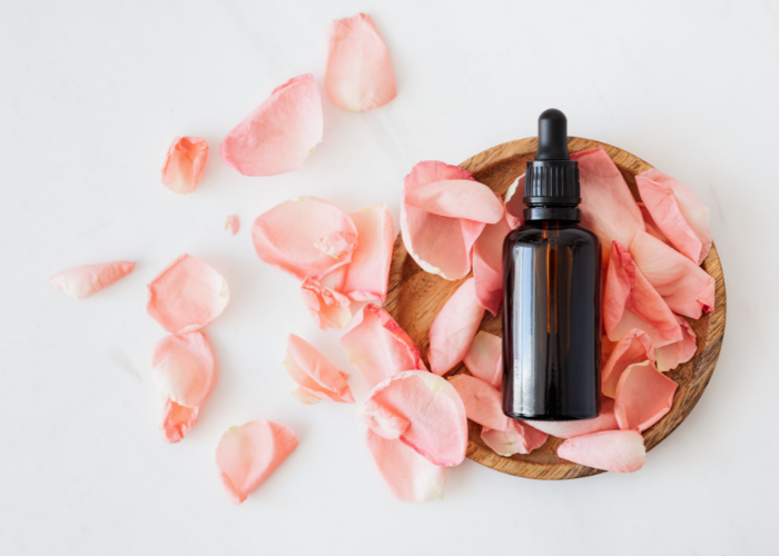Pink rose petals and essential oils, supplies for how to make potpourri
