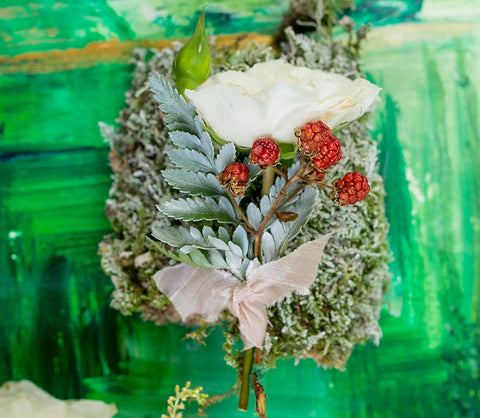 sage green boutonniere with red and white accents