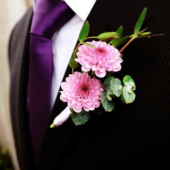 pink boutonniere with greenery