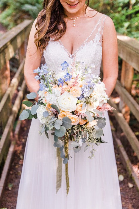 peach and light blue wedding bouquet with seeded eucalyptus
