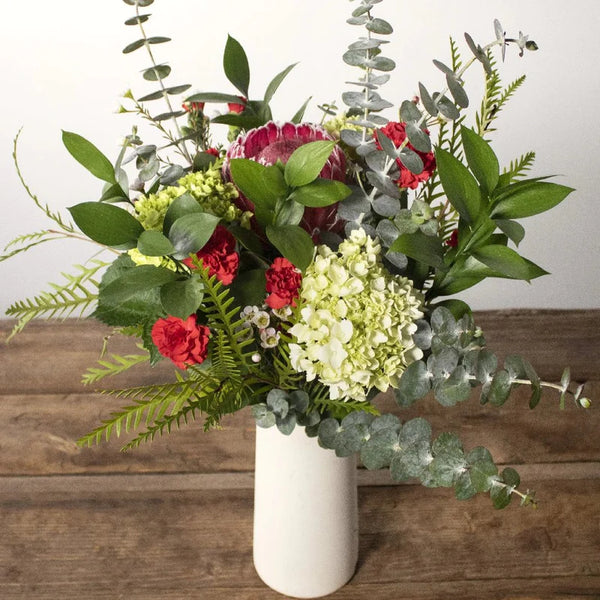 Flower bouquet in a white vase.