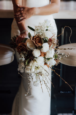 bride holding trending neutral colored bridal bouquet
