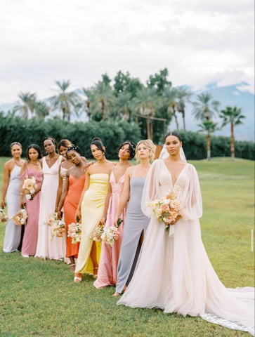 pastel bridesmaid dresses and bridesmaids holding pastel color scheme bouquets