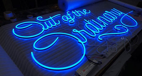 "Elevate your space with our striking blue 'Out of the Ordinary' LED neon sign. Unique and captivating, this neon art piece adds a touch of intrigue to any setting. Order now!"