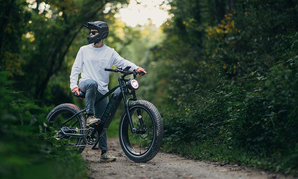 A man is off-road adventuring on a Brawn fat tire E-bike