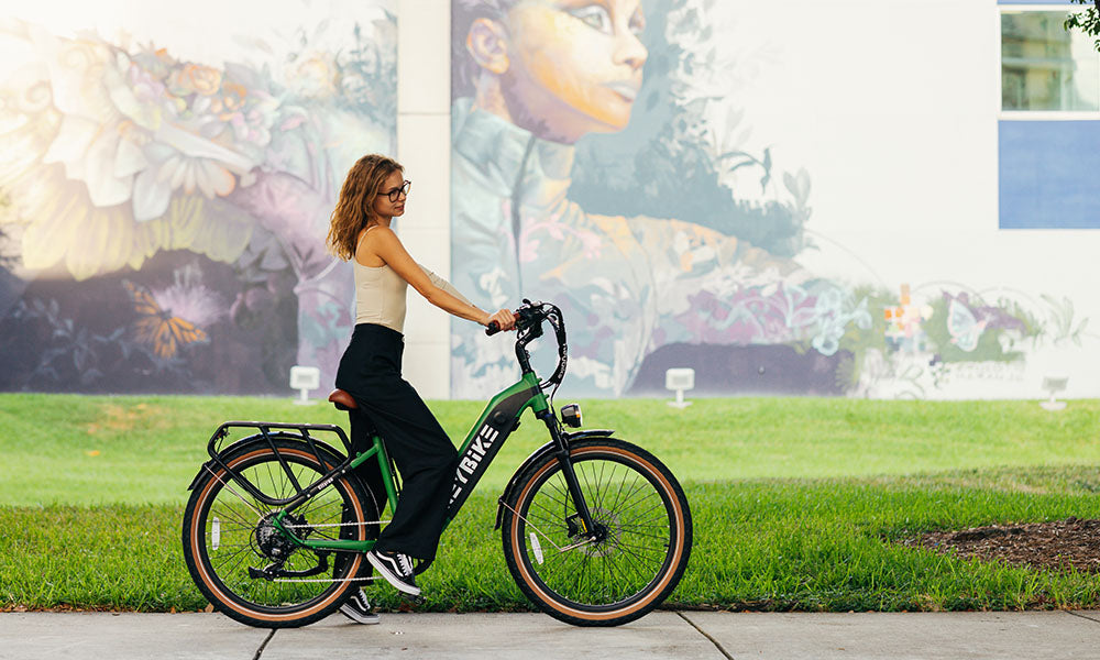 a woman is riding cityrun ebike on the road