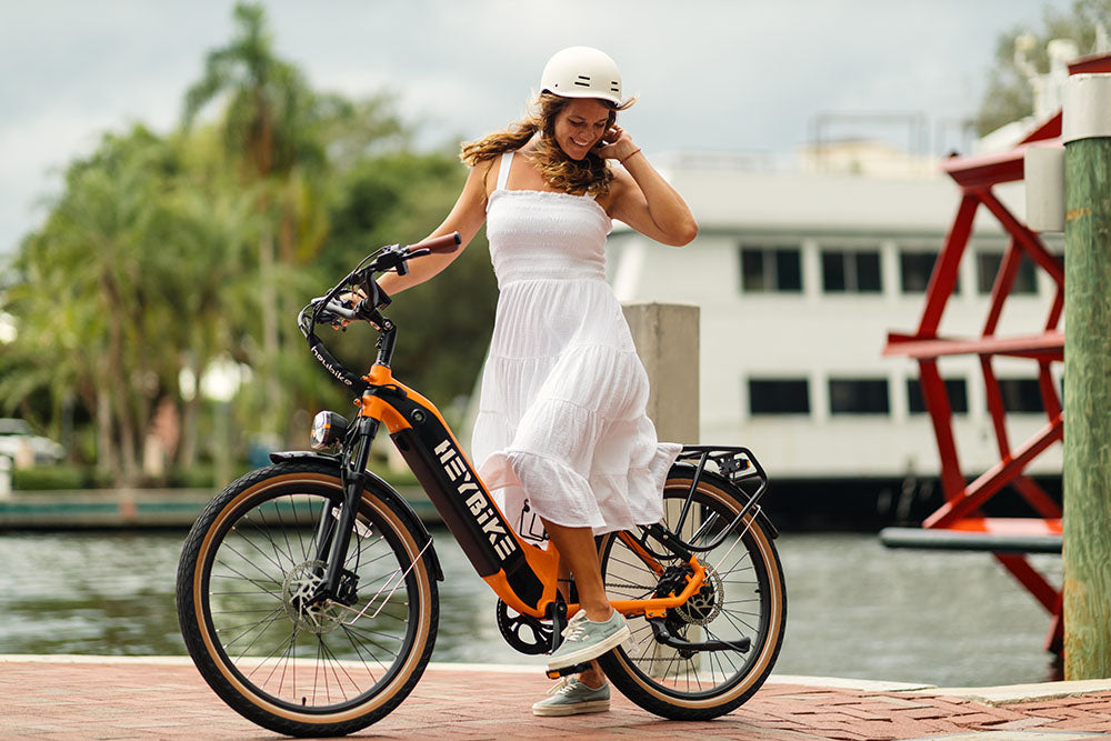A girl is riding a Cityrun thin-tire e-bike on the city road