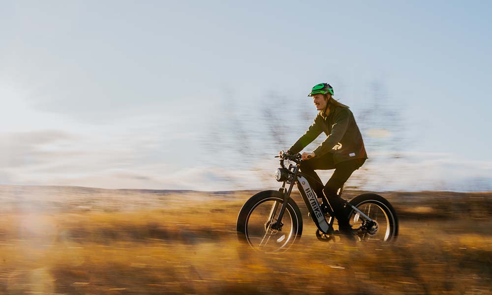 A man is riding a Brawn fat tire e-bike wild