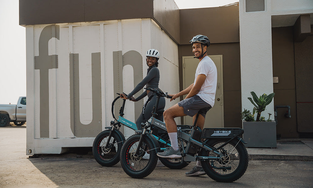 A man and a girl are riding the Mars 2.0 folding e-bike outside