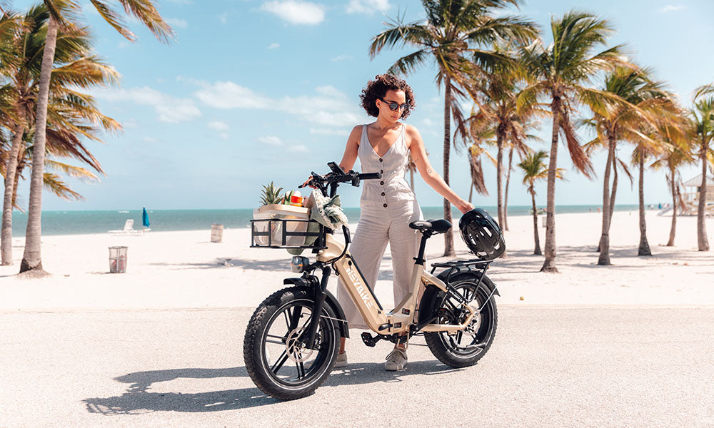 A mom is standing by her Ranger S e-bike on the beach