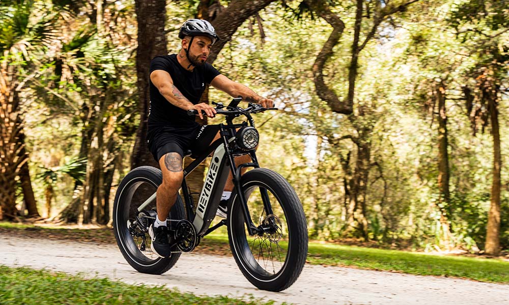 A man is riding a Heybike Brawn long-range ebike for outdoor adventure.