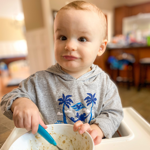 Austin eating oatmeal with Tiny Sprouts Superseed Boosters
