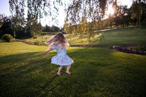 little girl dancing outside