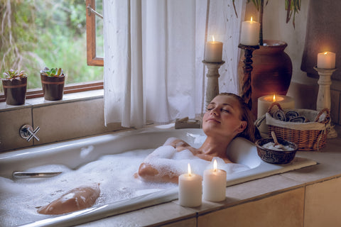 woman giving herself self care for valentine's day by enjoying a bath 