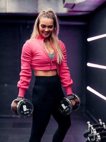 Happy female weightlifter during a strength training workout