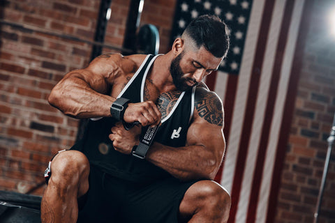 Weightlifter putting on his Versa Gripps before a workout