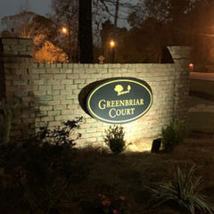 neighborhood entrance monument sign with ground lighting