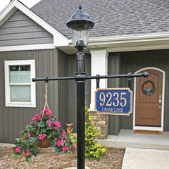 scalloped shaped address plaque on post mount with lantern and hanging basket