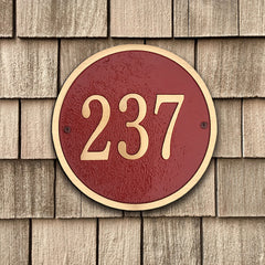 red and bronze circle house number plaque