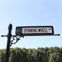 street signs and traffic sign on a decorative post