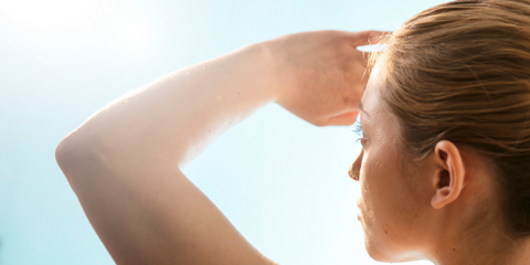 Woman squinting looking directly into the sun