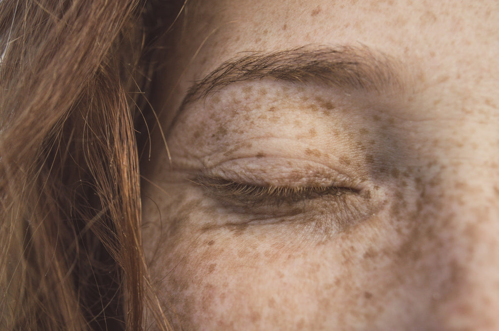 close up of woman's eye with freckles