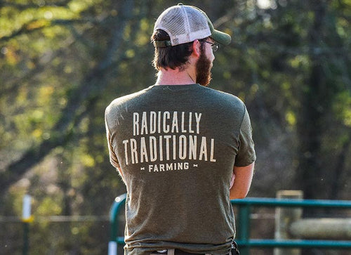 Farmer in t-shirt that reads Radically Traditional Farming