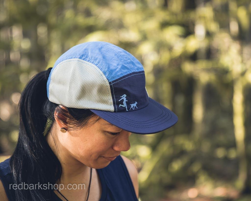 woman modelling blue and navy running hat for dog lovers