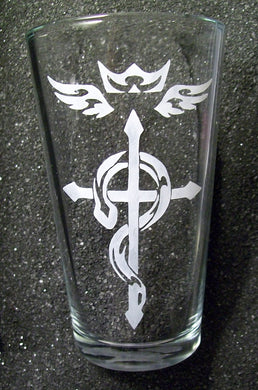 A pint glass etched with a tattoo-style version of the Flamel insignia from FMA. 