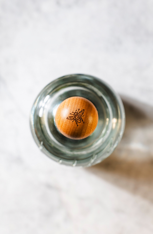 Secret Garden Distillery new bespoke bottle features an engraved bee on every wooden stopper