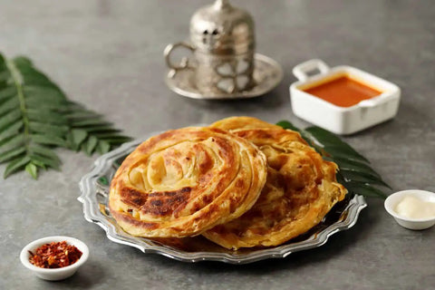 Roti Canai served in a silver plate with chutney