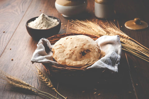 Wheat roti in a basket on a wooden table