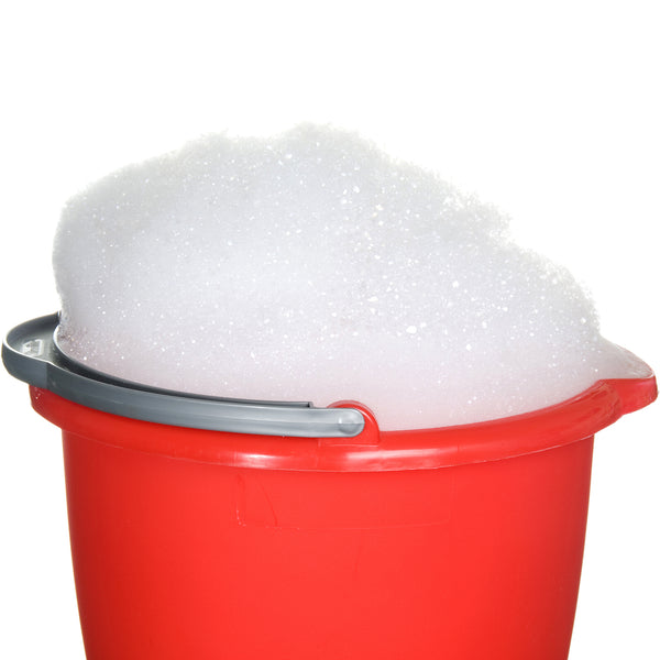 Bucket of foamy liquid that has foamed due to being filled using the wrong piston filler