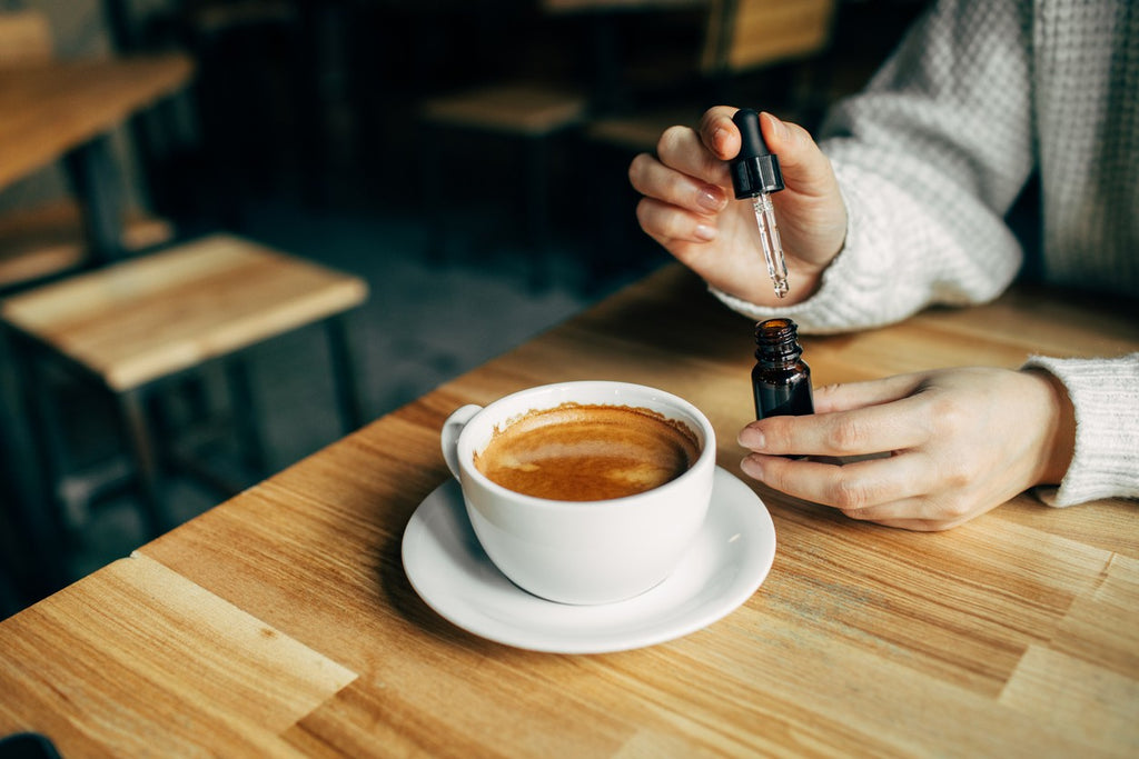 woman-adding-cbd-oil-to-coffee