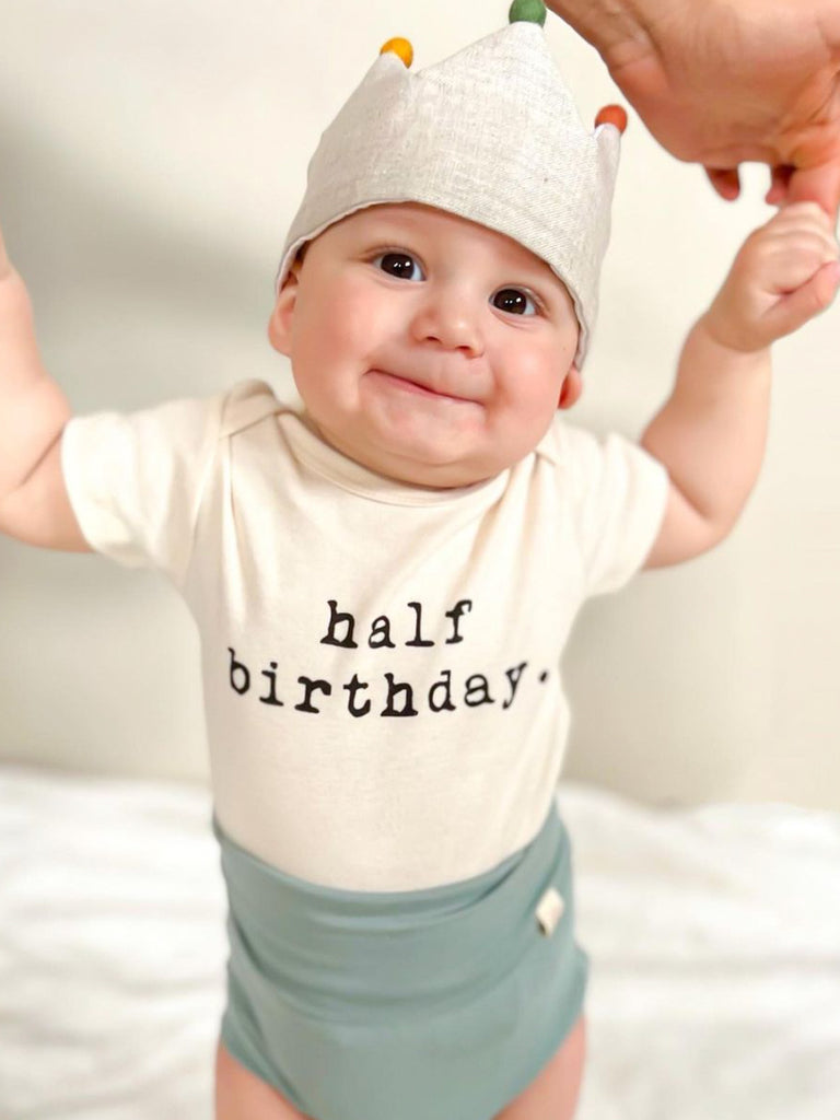 half birthday onesie with baby wearing a birthday crown