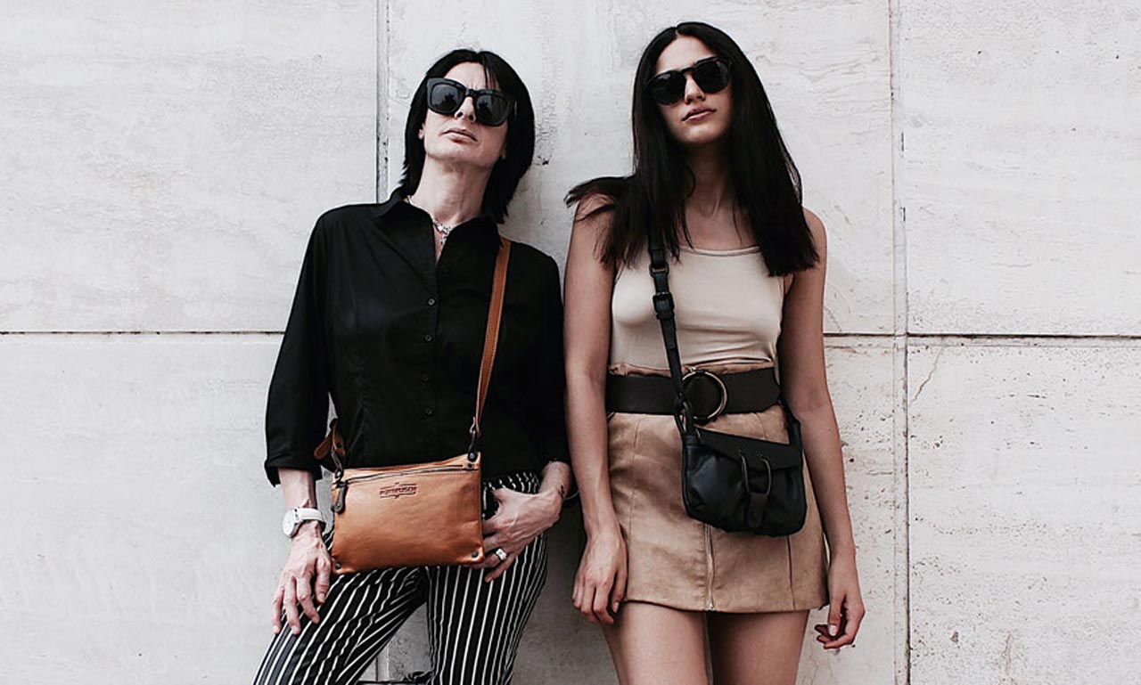 Two women carry Margelisch leather handbags