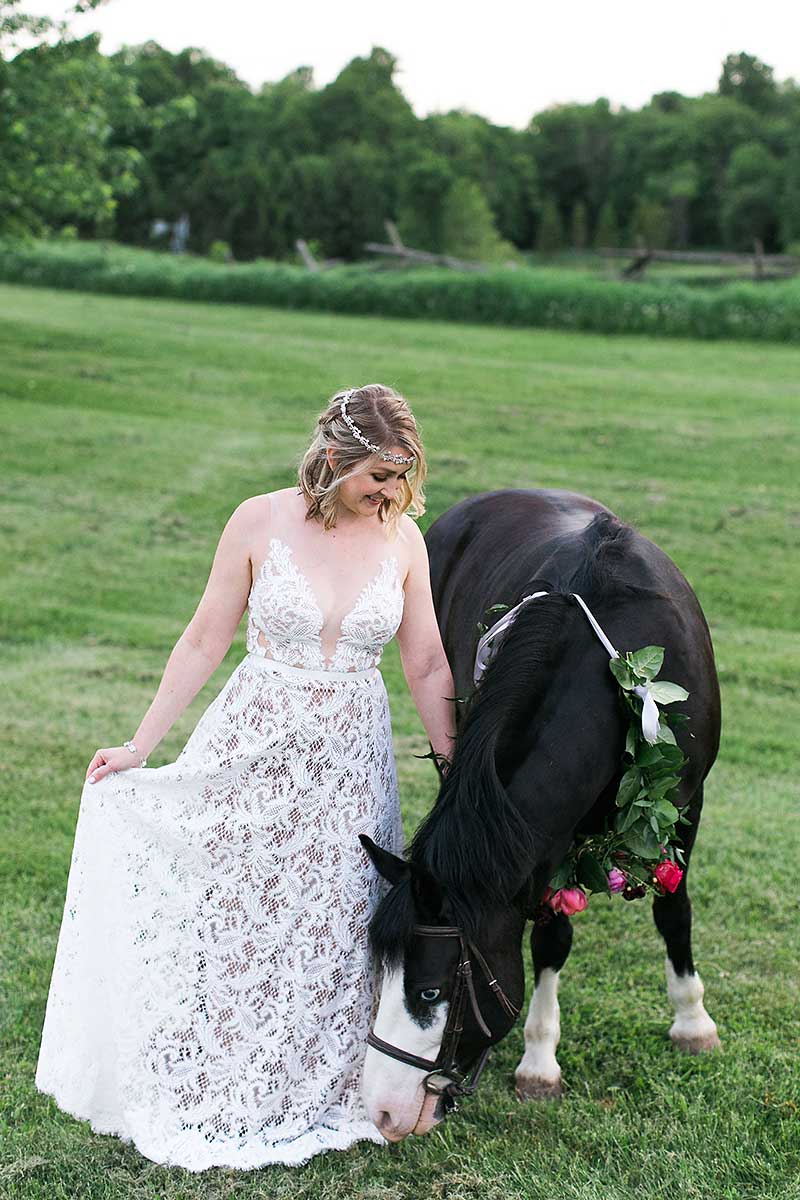 Bohemian free spirit smiling bride with a horse 