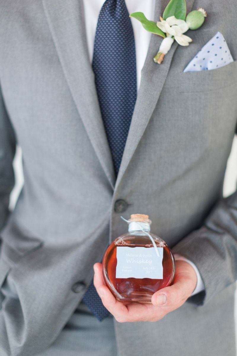 groom standing with bourbon 