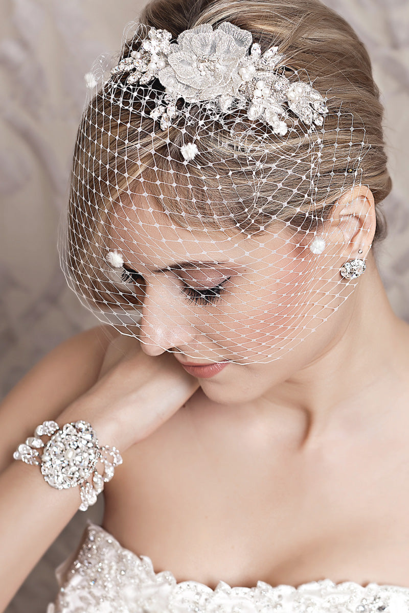 Side profile of bride wearing Celeste flower hair comb with birdcage veil by Laura Jayne..