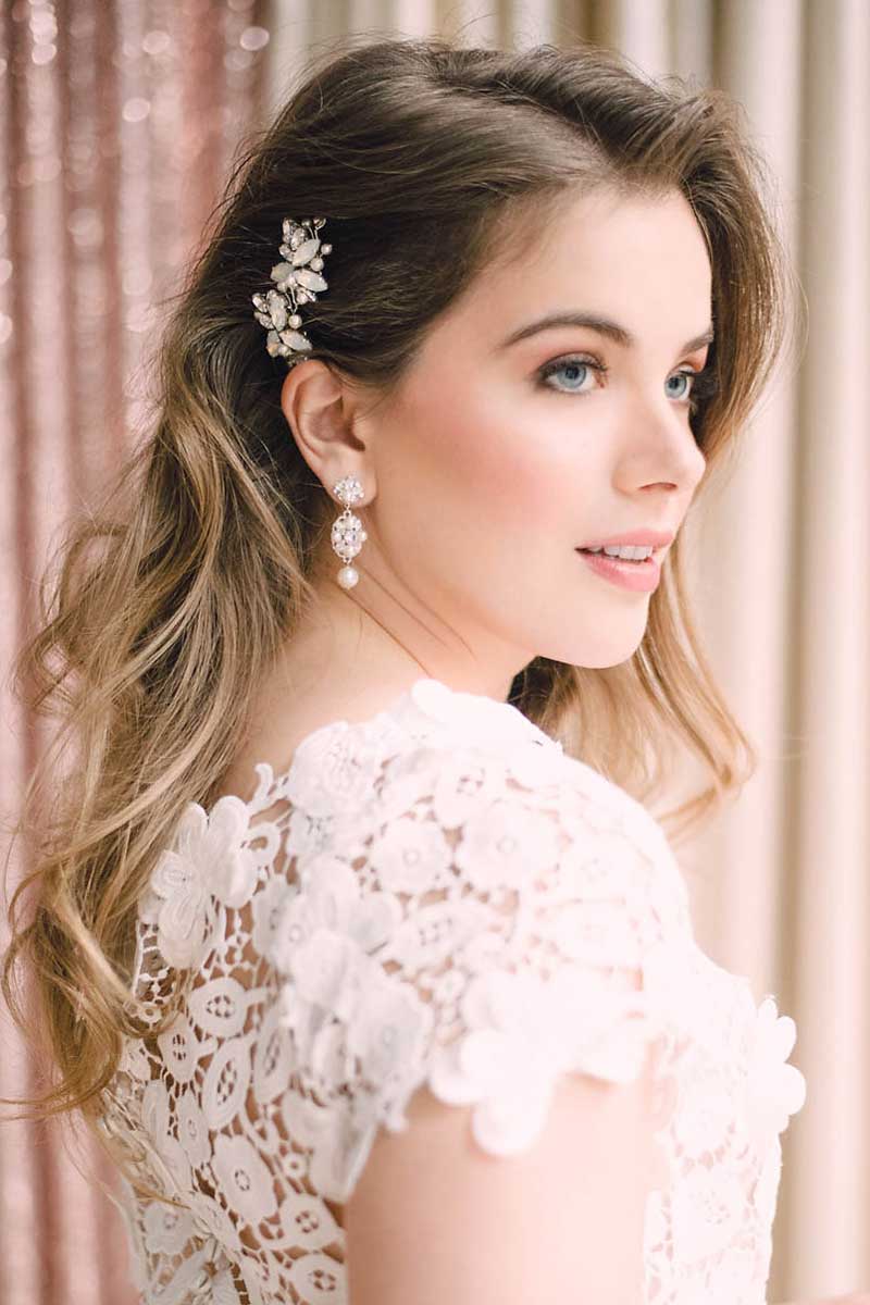 Profile view of bride with effortless waves hairstyle and small side combs hair accessories